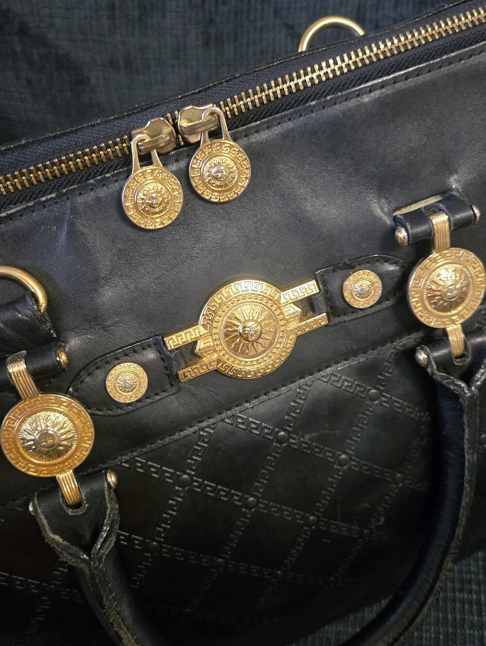 Black Leather Handbag with Gold Medallion Accents